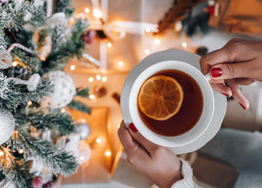 https://www.pexels.com/photo/crop-unrecognizable-woman-holding-cup-of-tea-near-christmas-tree-6408296/